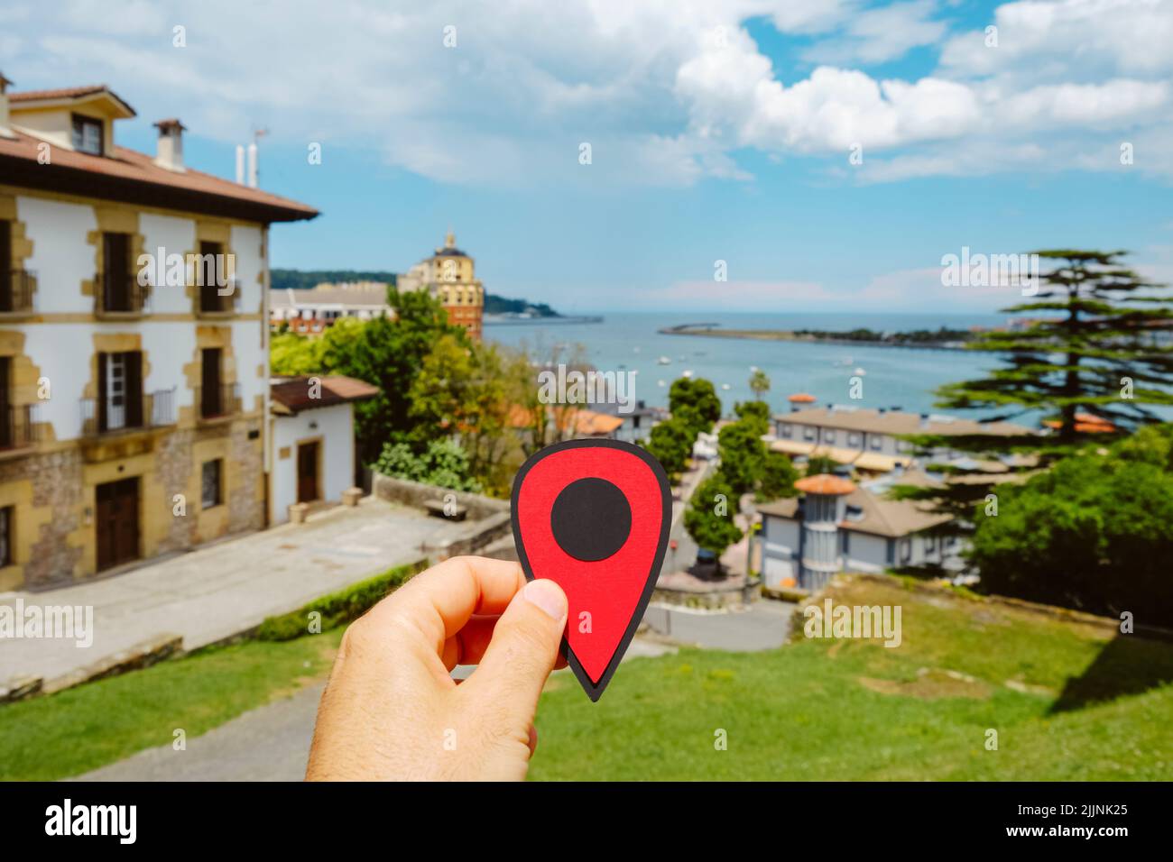 closeup of the hand of a man holding a red marker in Hondarribia, Spain, and the mouth of the Bidassoa river and the Bay of Txingudi in the Atlantic o Stock Photo
