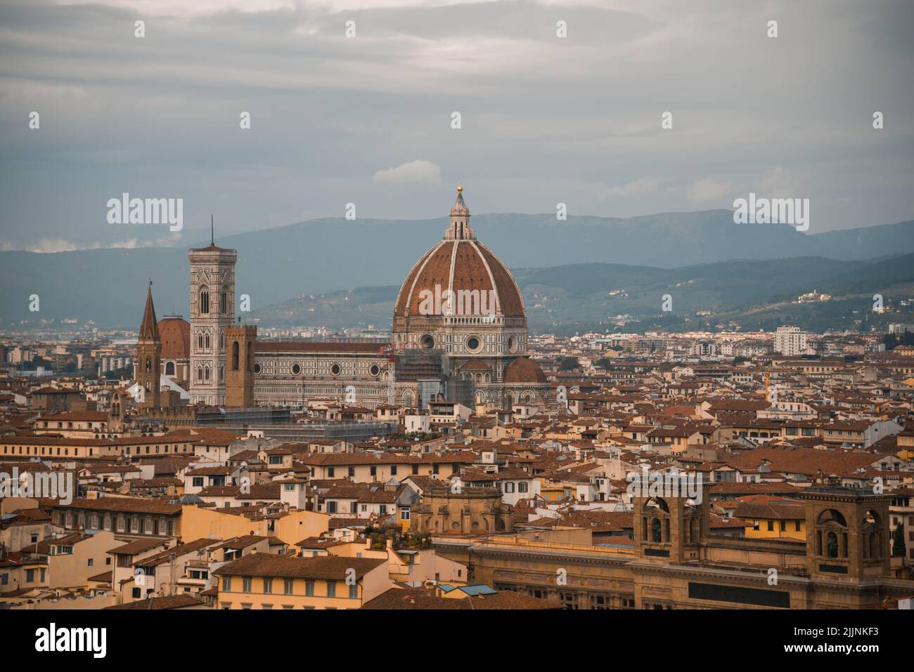 A view of Florence Cathedral (Cathedral of Saint Mary of the Flower) in a background of mountains Stock Photo
