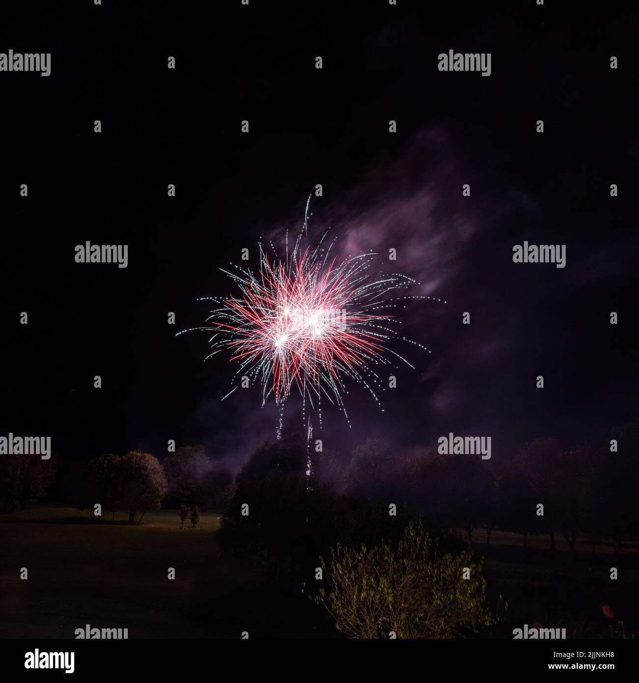 A beautiful background of a firework in night black sky Stock Photo