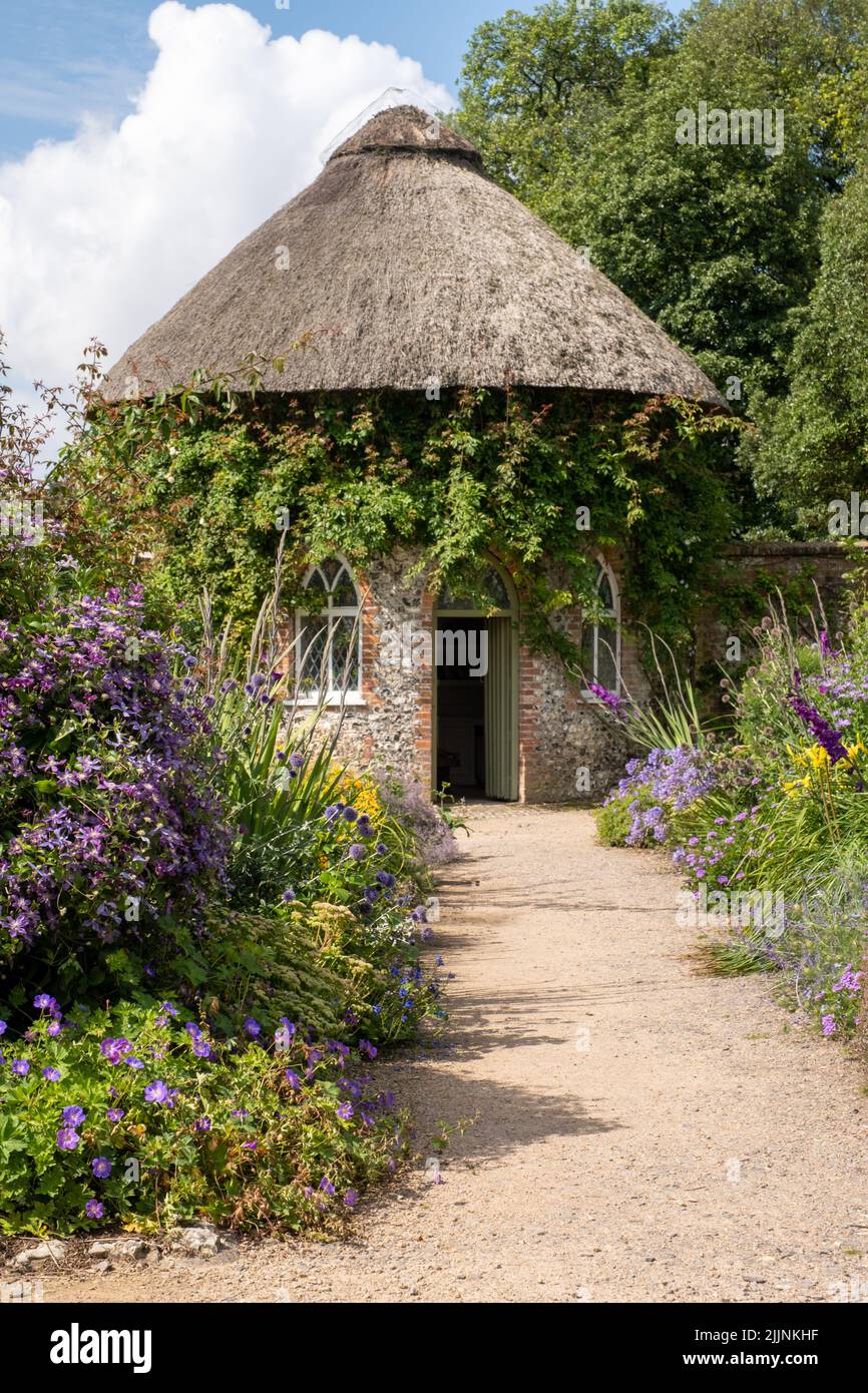 A small beautiful Thatched garden house at West Dean Gardens, UK Stock Photo