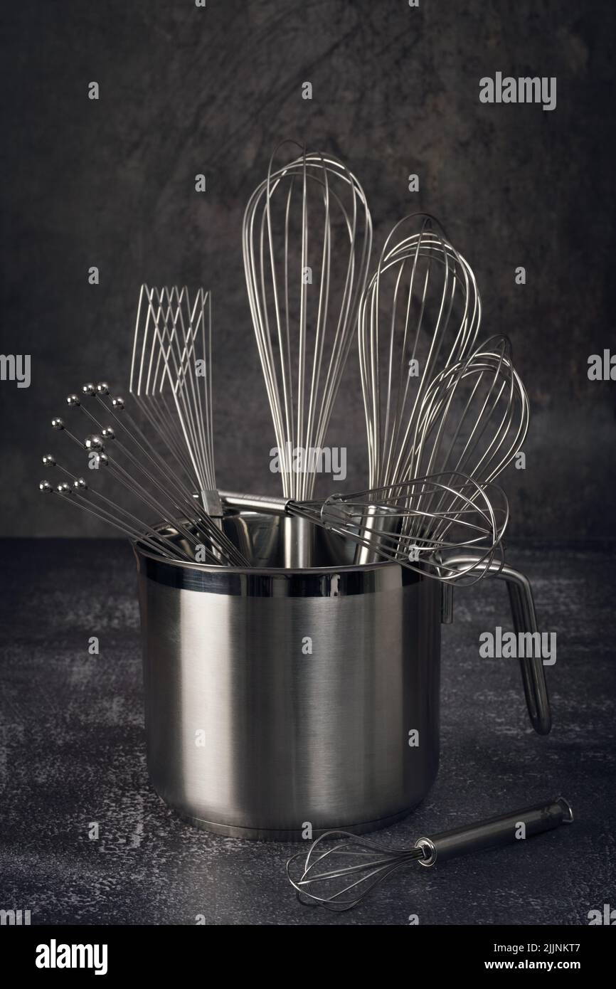 https://c8.alamy.com/comp/2JJNKT7/a-closeup-shot-of-metal-baking-utensils-set-in-a-container-put-on-a-kitchen-table-2JJNKT7.jpg