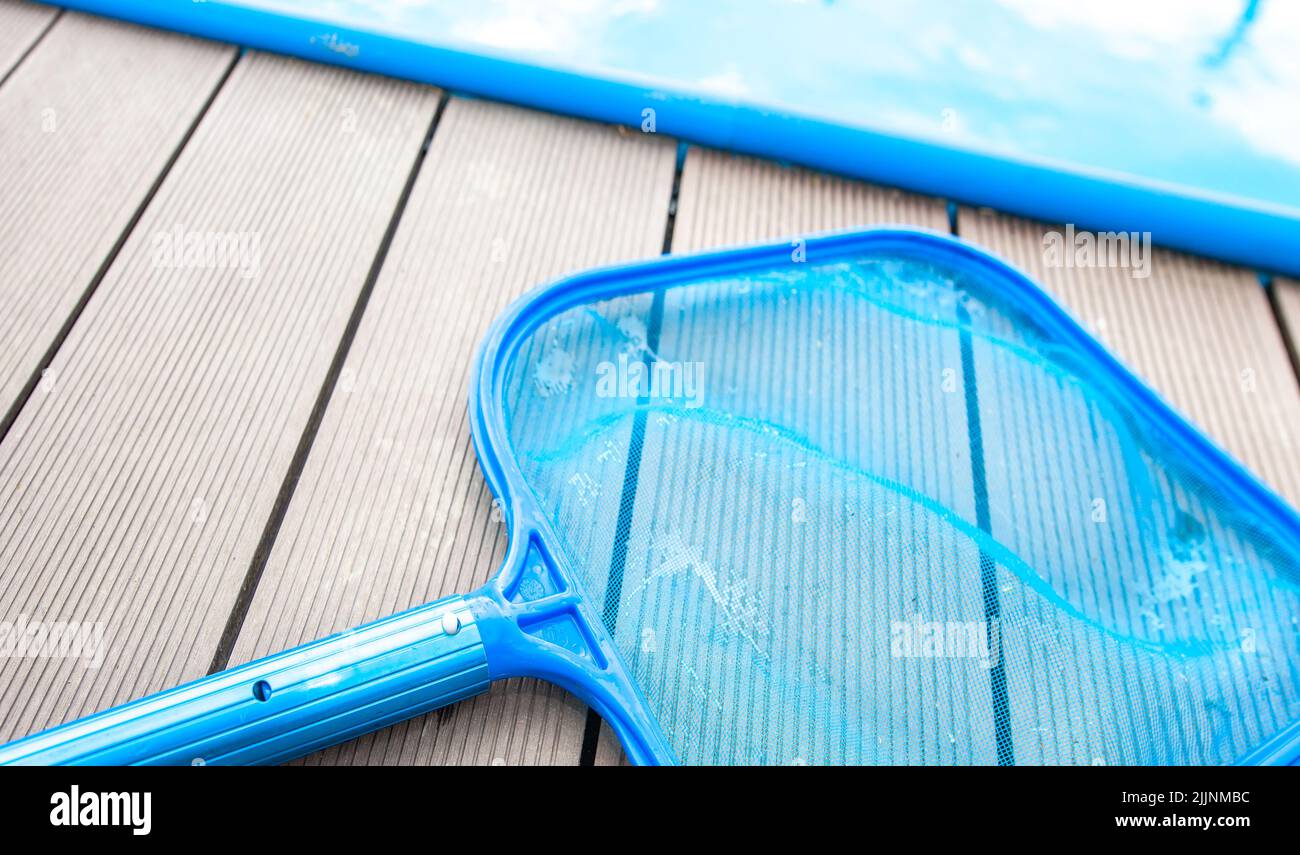 Process of cleaning swimming pool by a hand net during summer time
