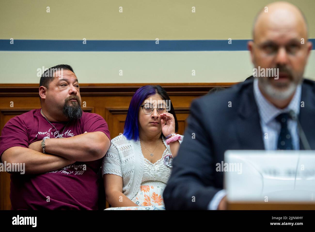 Jazmin Cazares, center, whose nine year-old sister Jacklyn Cazares, was one of the children killed by a gunman at Robb Elementary School in Uvalde, Texas, is seated next to her father Javier Cazares, left, during a House Committee on Oversight and Reform hearing “Examining the Practices and Profits of Gun Manufacturers” in the Rayburn House Office Building in Washington, DC, July 27, 2022. Credit: Rod Lamkey/CNP /MediaPunch Stock Photo