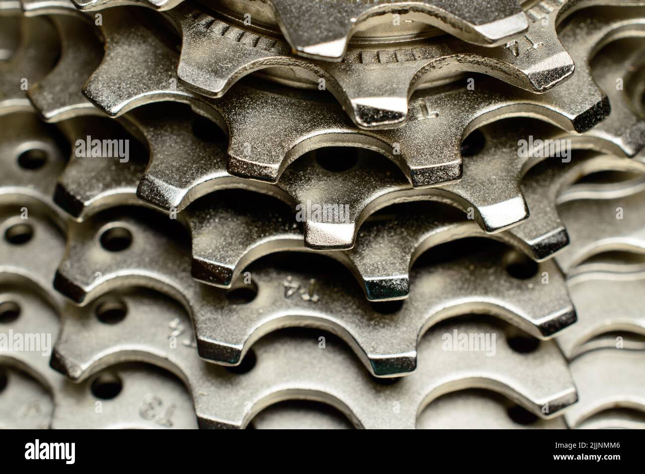 Bike rear cassette 11 speeds, bicycle spare parts, on a black background. Macro photo, selective focus. Stock Photo