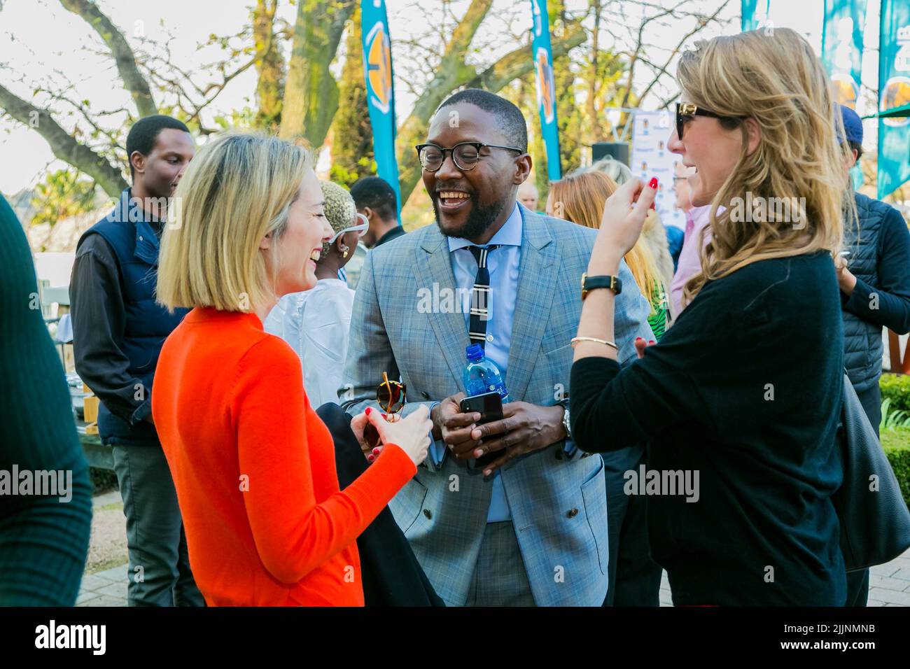 The VIP guests mingling at an outdoor social event Stock Photo