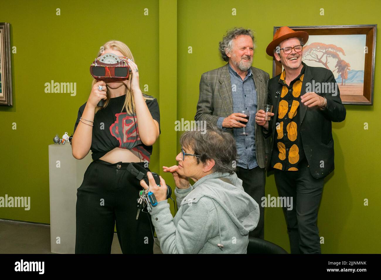 A group of visitors viewing paintings in an art gallery in a good mood, Johannesburg, South Africa Stock Photo