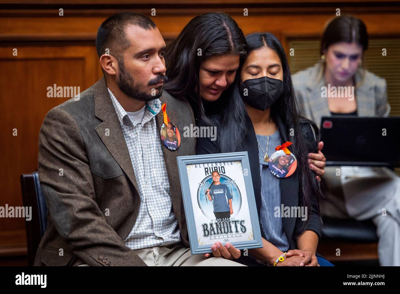 Gloria Cazares, center, whose nine year-old daughter Jacklyn was one of the children killed by a gunman at Robb Elementary School in Uvalde, Texas, comforts Felix Rubio, left, and Kimberly Rubio, right, whose daughter Alexandria Rubio was one of the children killed by a gunman at Robb Elementary School in Uvalde, Texas, during a House Committee on Oversight and Reform hearing “Examining the Practices and Profits of Gun Manufacturers” in the Rayburn House Office Building in Washington, DC, July 27, 2022. Credit: Rod Lamkey/CNP /MediaPunch Stock Photo