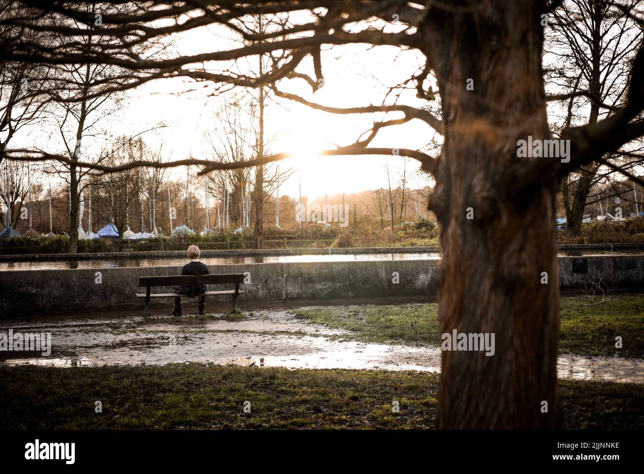 A view of the boy sitting alone on the bench in the park Stock Photo ...
