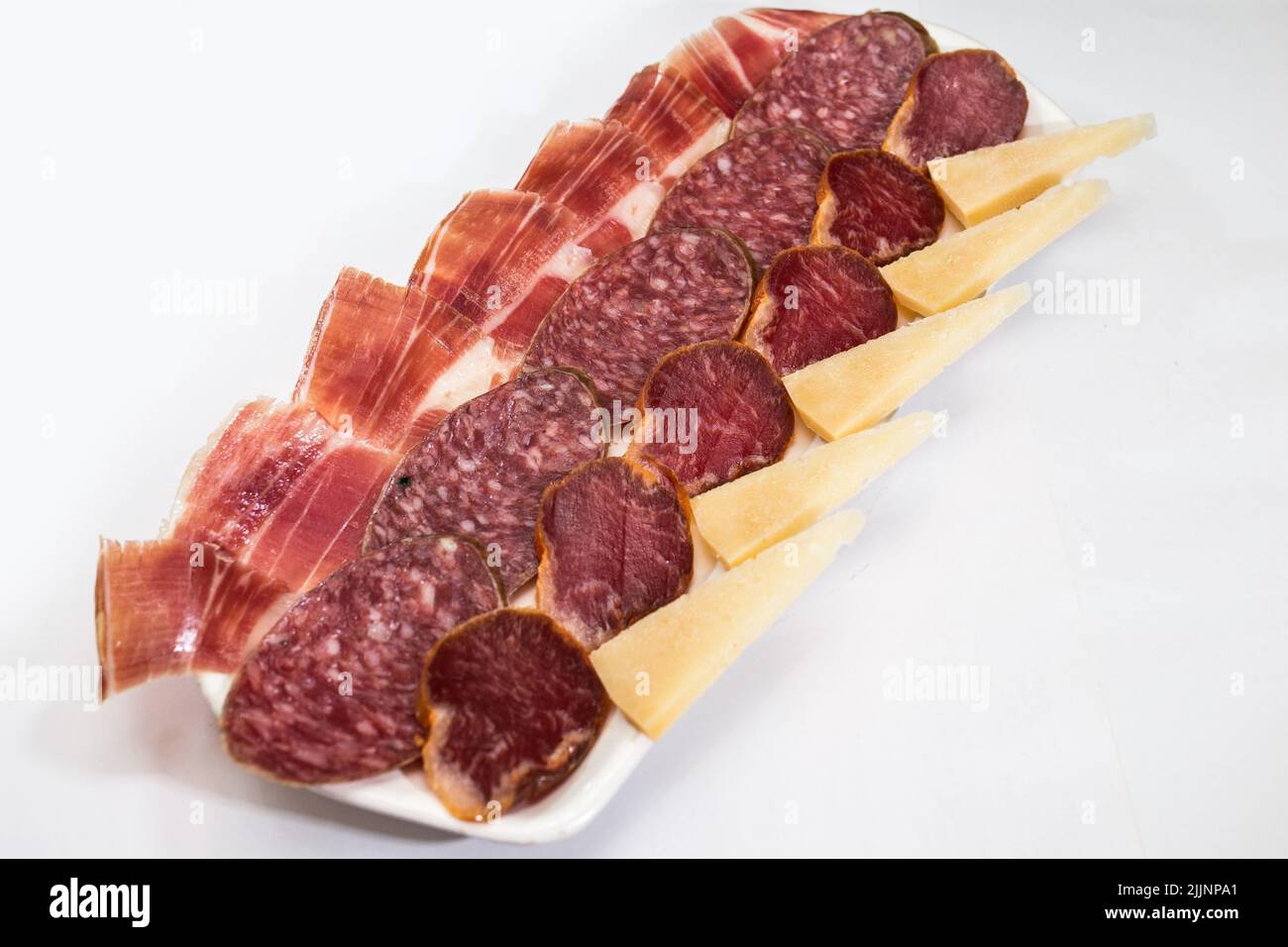 A closeup shot of cut meats on a plate Stock Photo