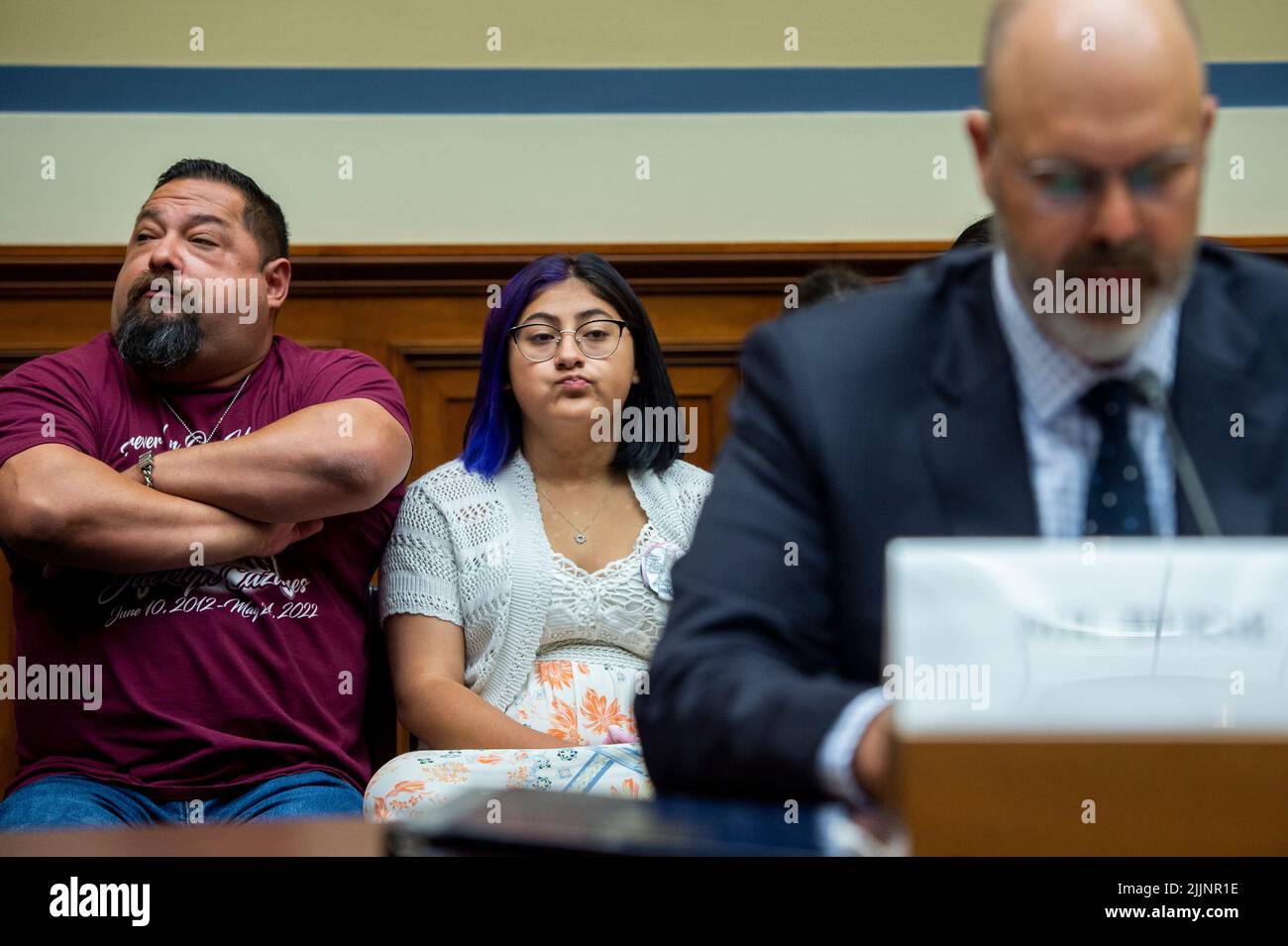 Washington, Vereinigte Staaten. 27th July, 2022. Jazmin Cazares, center, whose nine year-old sister Jacklyn Cazares, was one of the children killed by a gunman at Robb Elementary School in Uvalde, Texas, is seated next to her father Javier Cazares, left, during a House Committee on Oversight and Reform hearing âExamining the Practices and Profits of Gun Manufacturersâ in the Rayburn House Office Building in Washington, DC, July 27, 2022. Credit: Rod Lamkey/CNP/dpa/Alamy Live News Stock Photo