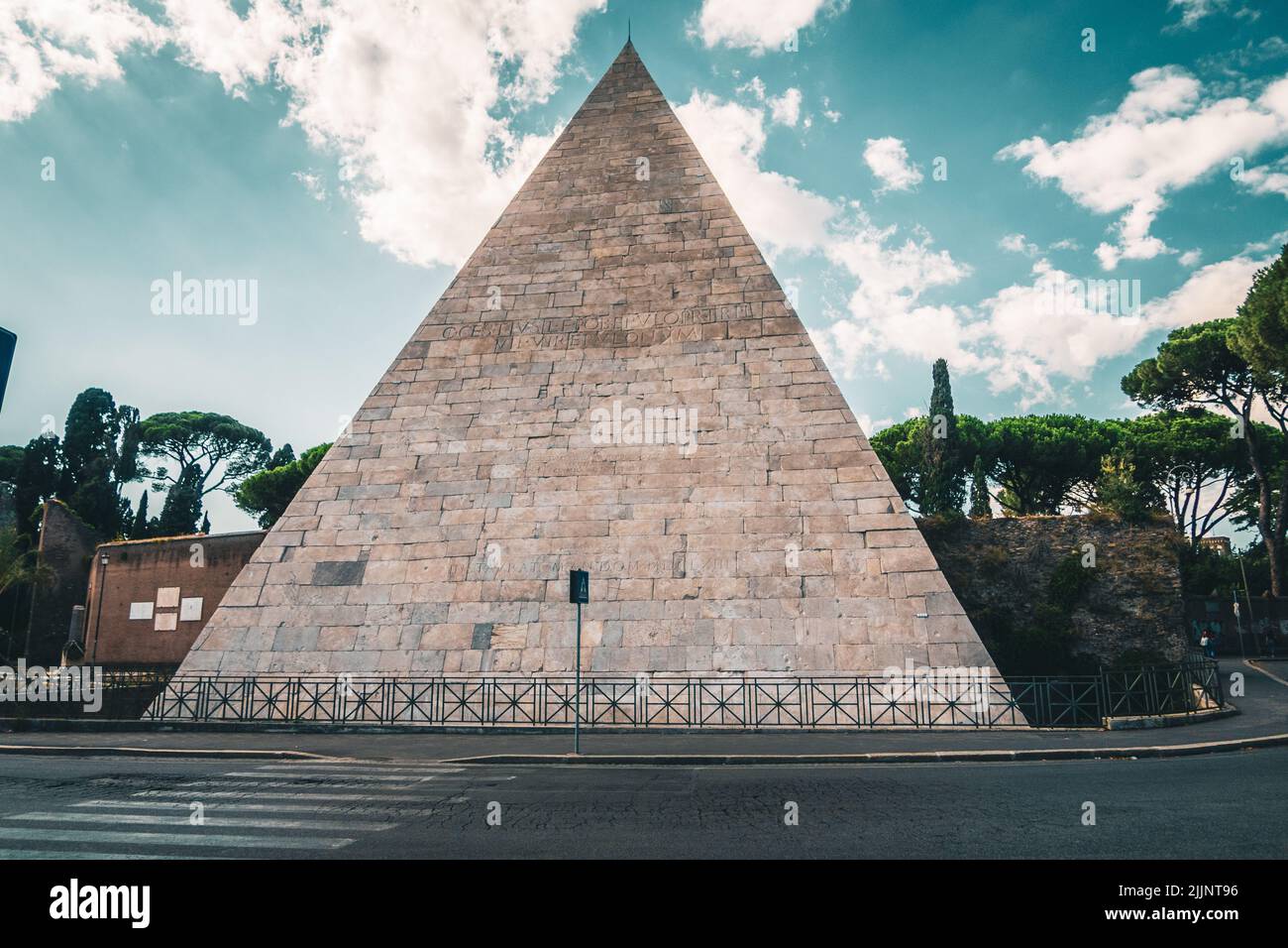 The Pyramid of Caius Cestius against a cloudy sky in Rome, Italy Stock Photo