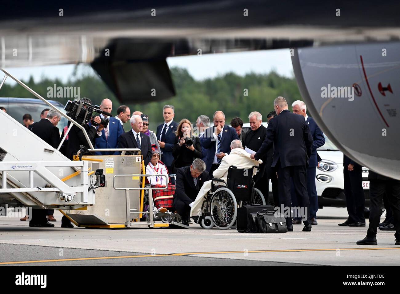 Quebec, Canada. 26th July, 2022. Pope Francis sits in a wheelchair after arriving by plane at the airport in Quebec. As part of his six-day trip to Canada, Pope Francis plans to celebrate Mass at the National Shrine and meet church representatives in Quebec City this Thursday. Credit: Johannes Neudecker/dpa/Alamy Live News Stock Photo
