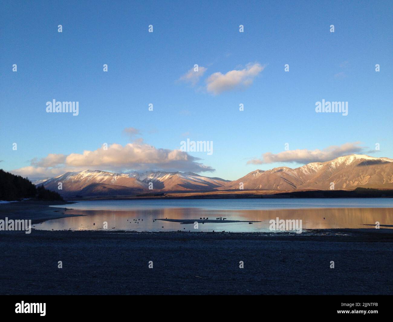 A beautiful view of Lake Tekapo in New Zealand during sunset Stock ...