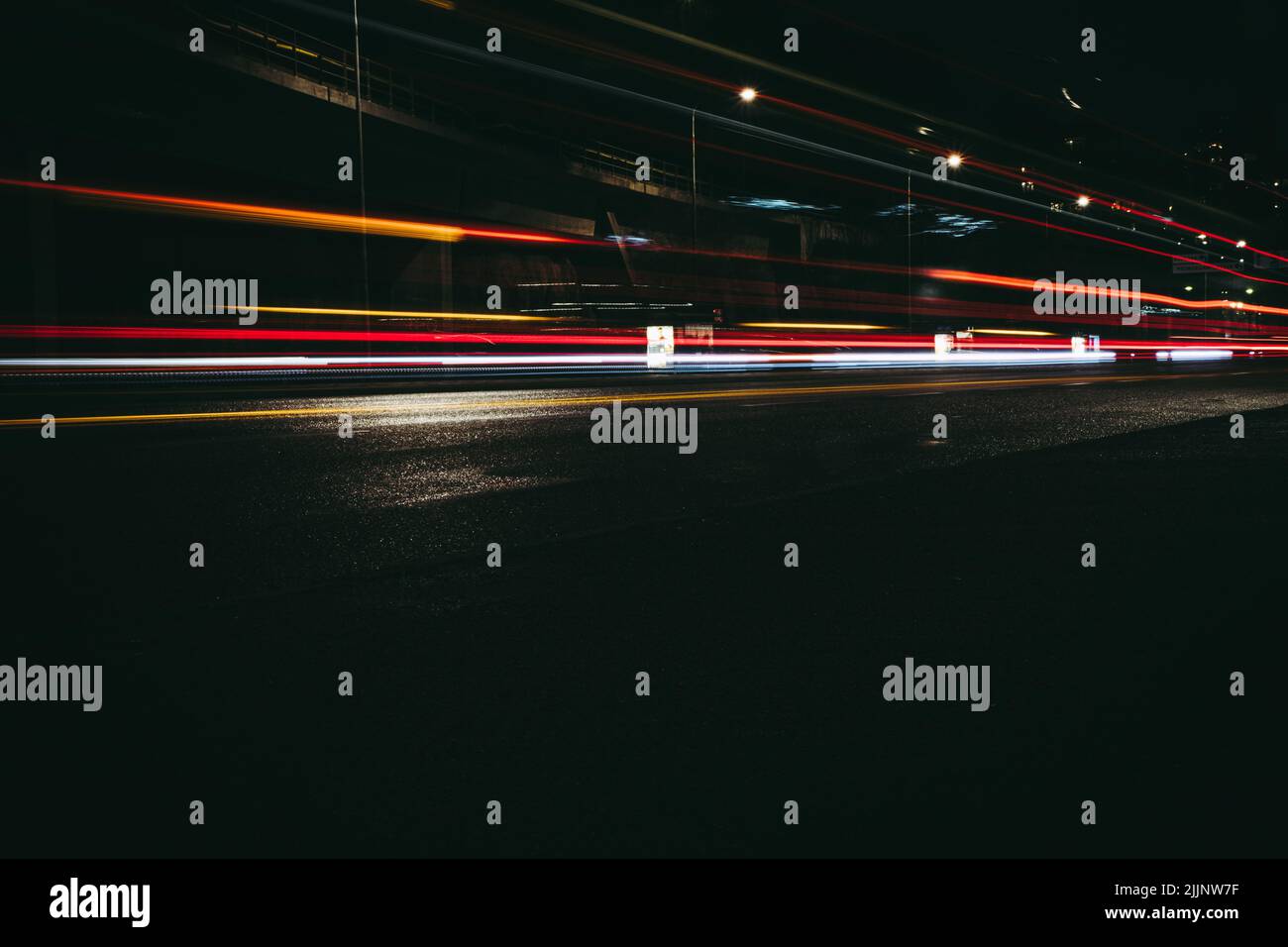 A long exposure shot of the traffic lights at night Stock Photo