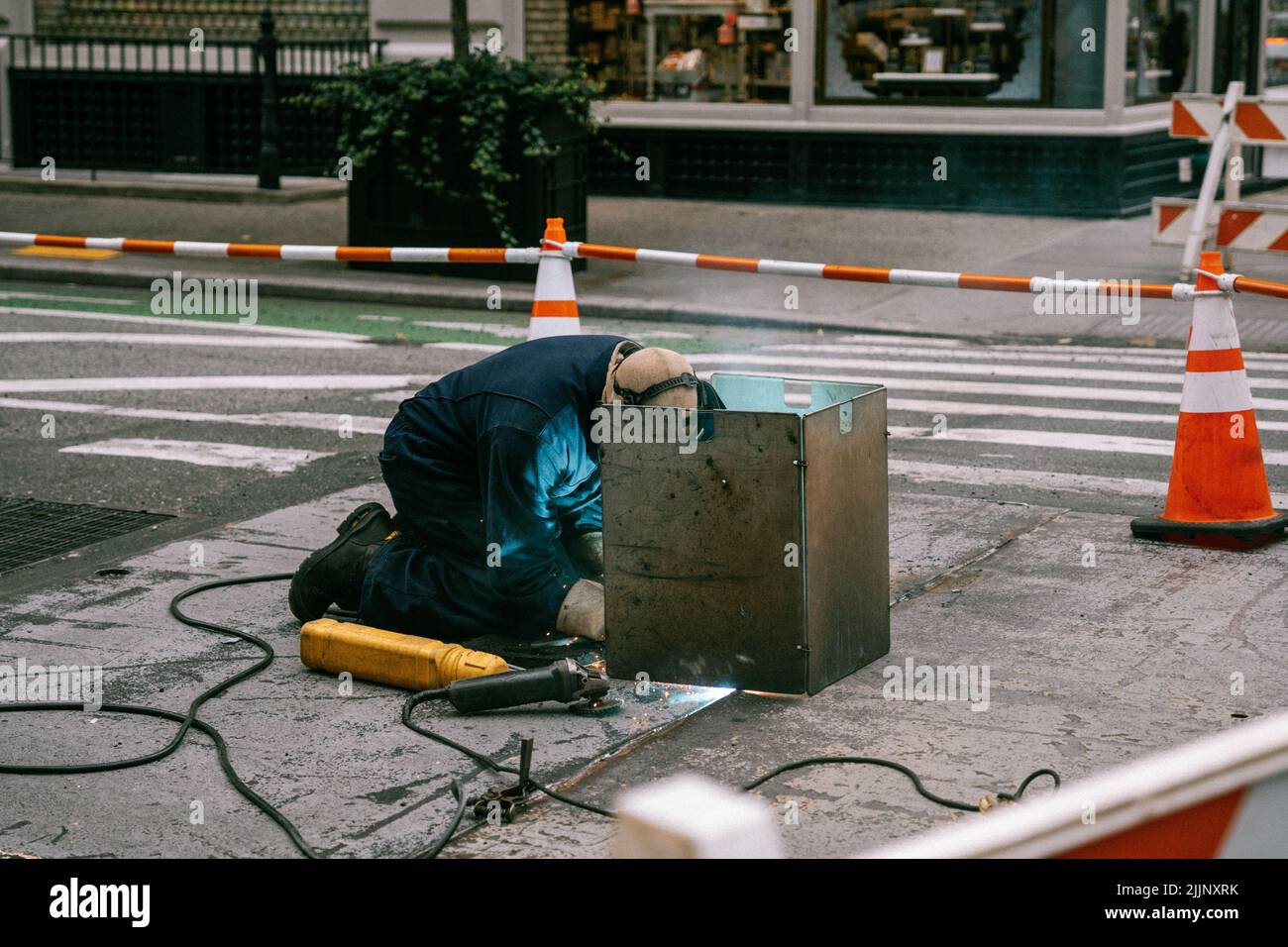 A closeup of the welder working on the street. Stock Photo