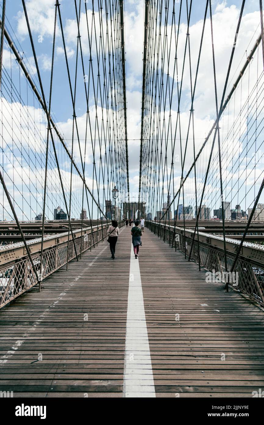 Walking across the Brooklyn Bridge in New York City Stock Photo - Alamy