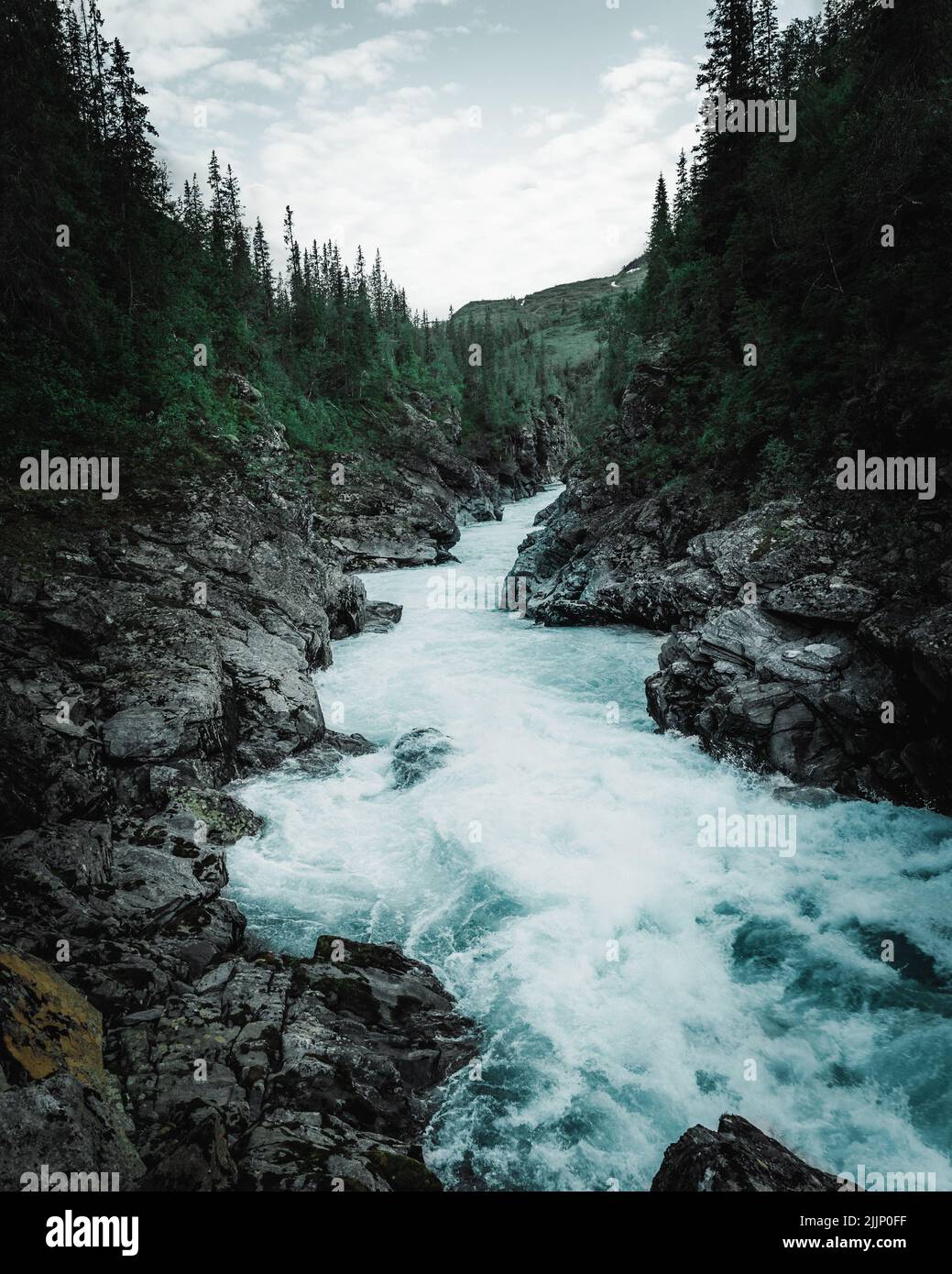 A vertical shot of the landscape with river passing through rocky ...