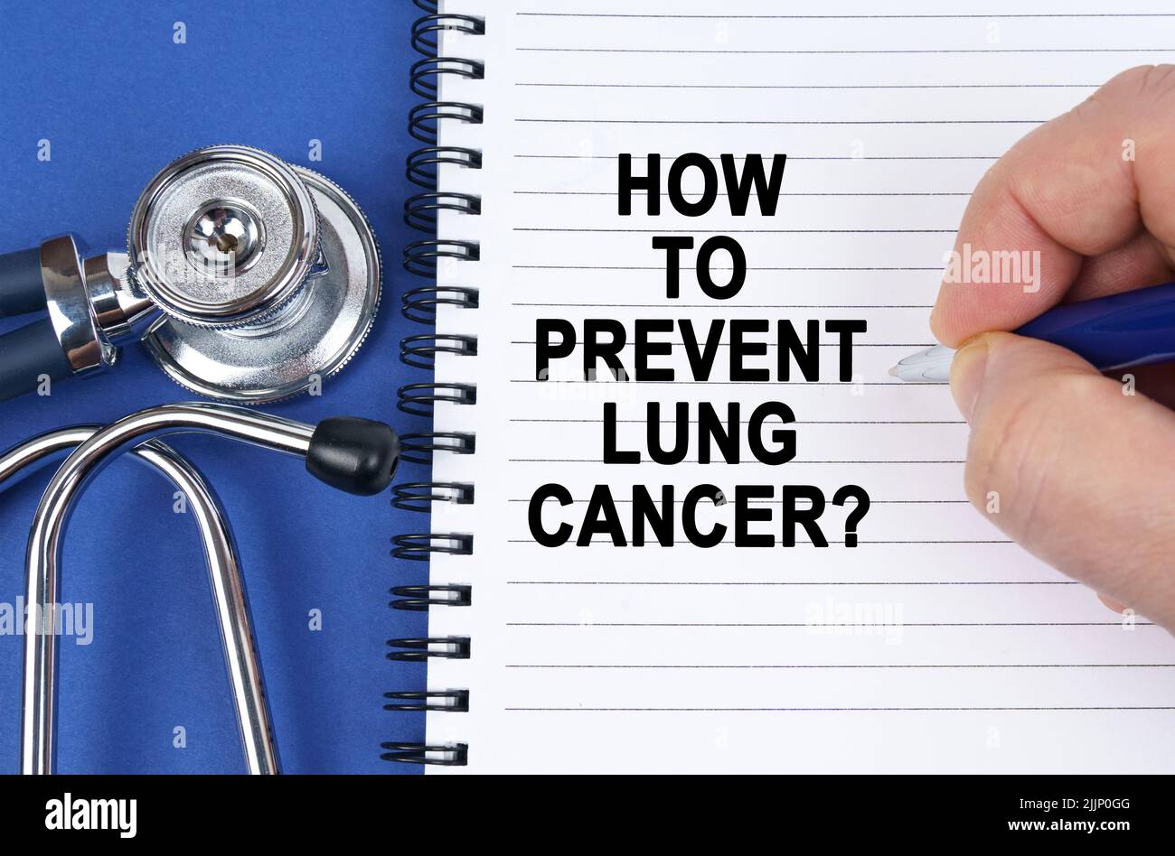 Medical concept. On a blue surface lies a stethoscope and a notebook in which it is written by hand - How to Prevent Lung Cancer Stock Photo