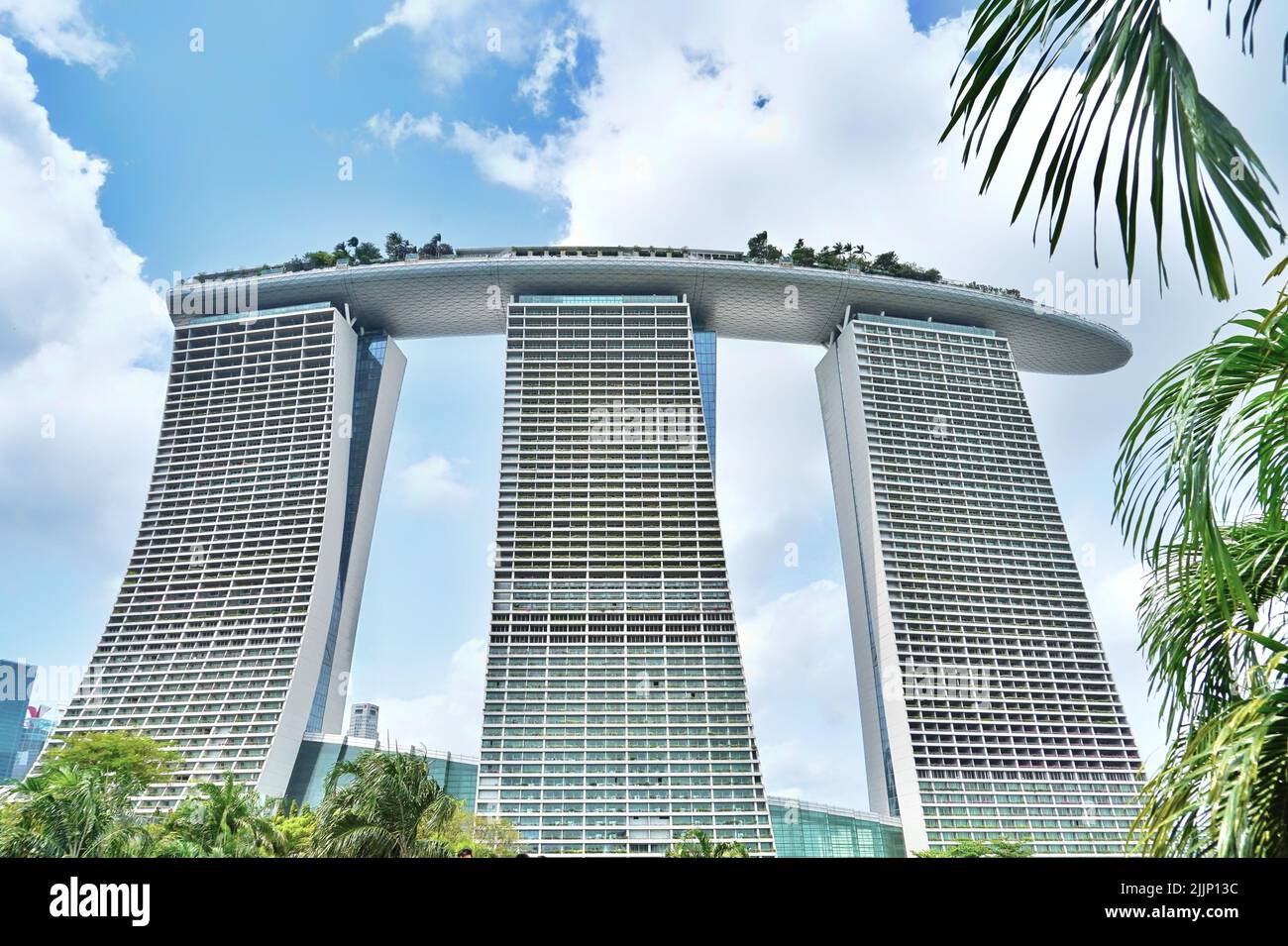 A low angle shot of the famous Marina Bay Sands hotel in Singapore under a bright cloudy summer sky Stock Photo