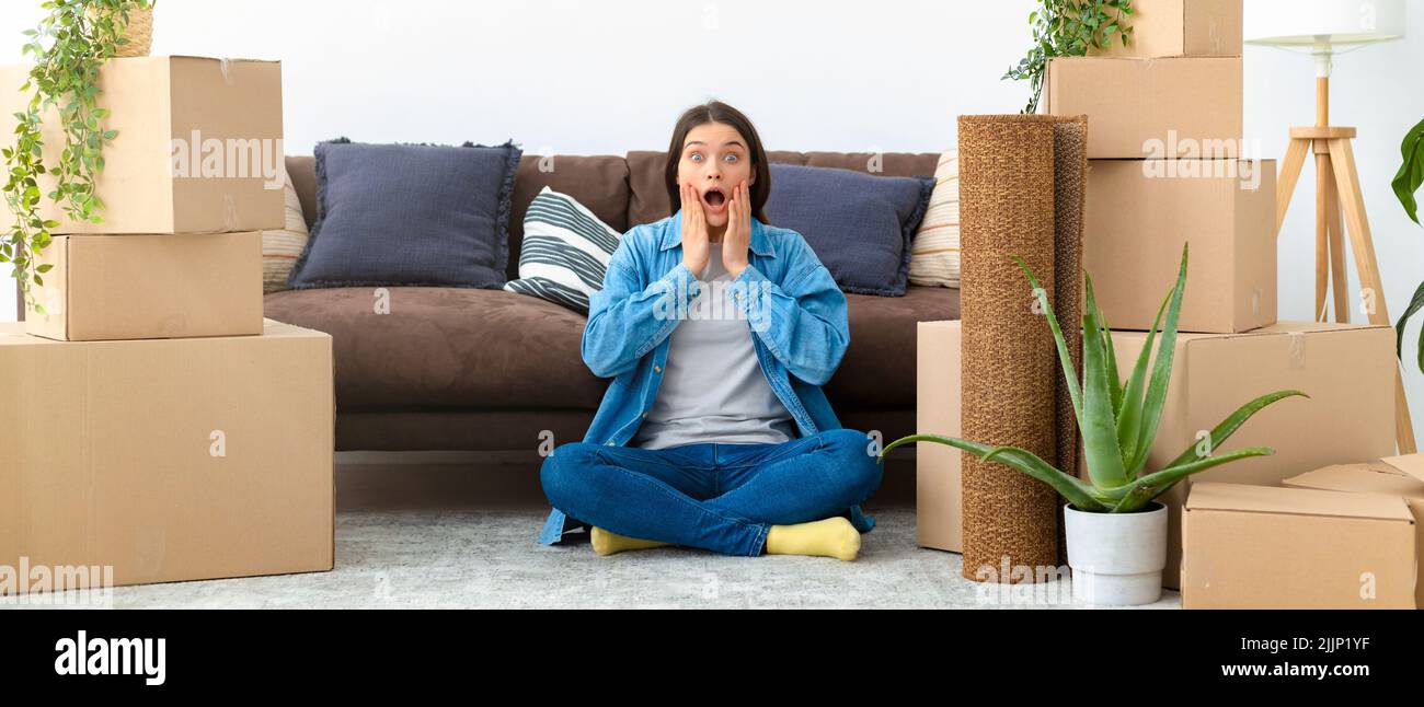 Moving to new house rental housing Happy young woman with cardboard