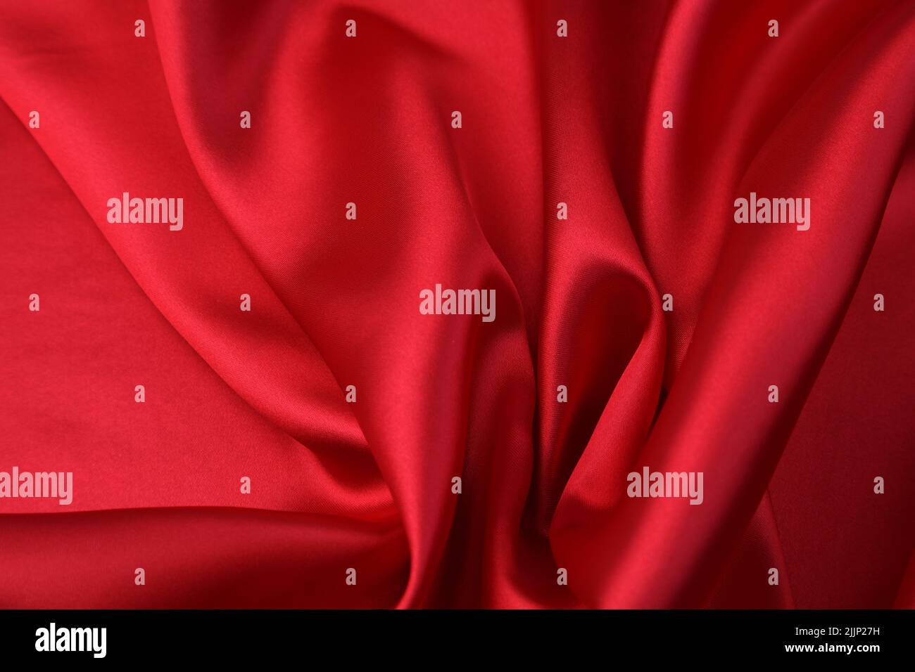 Closeup of rippled red silk fabric Stock Photo