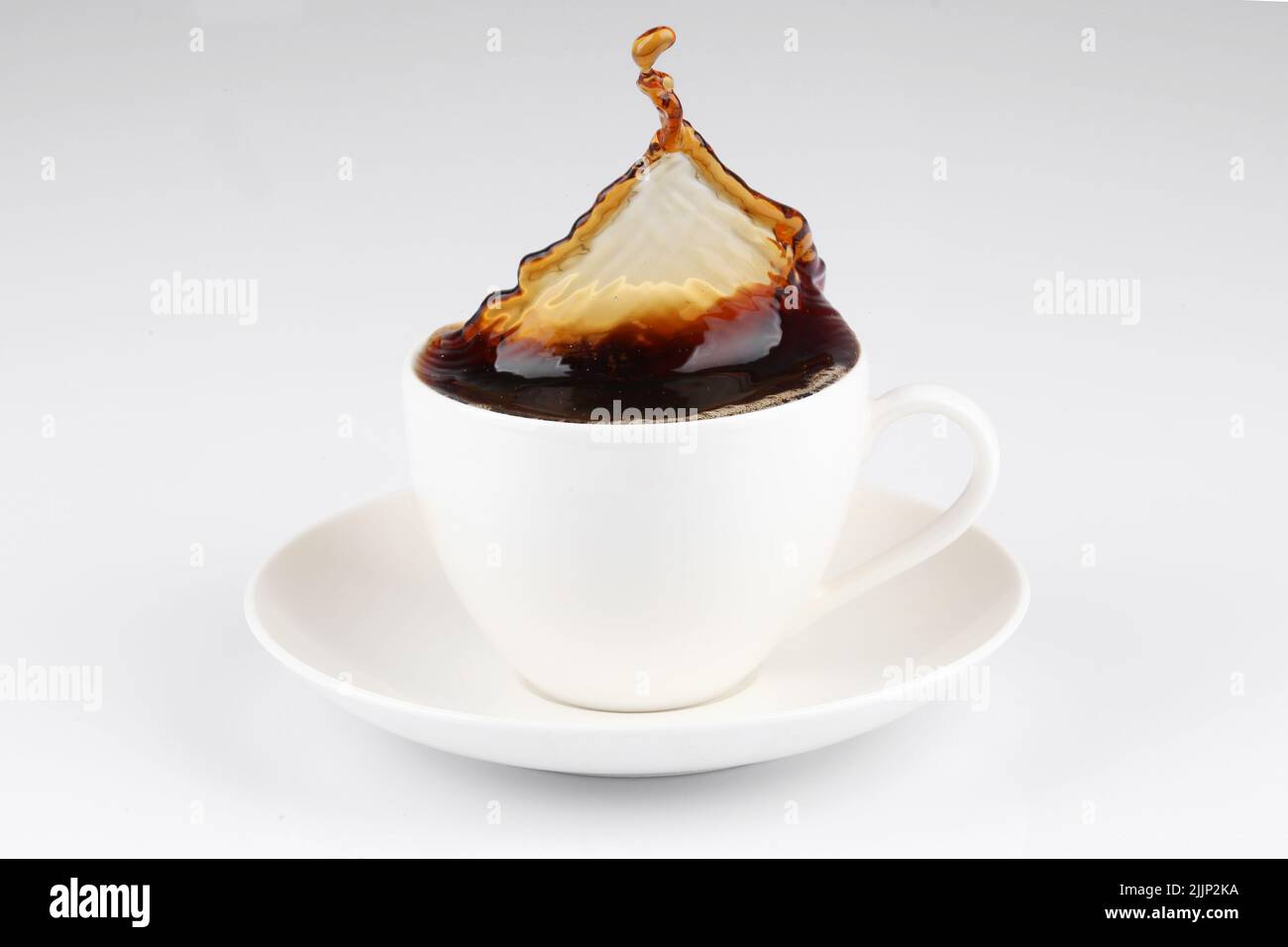 A coffee splash from a cup isolated on white background Stock Photo