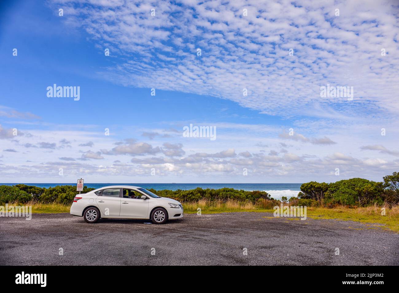 A white car on the Ocean Road Roadside Melbourne Australia Stock Photo