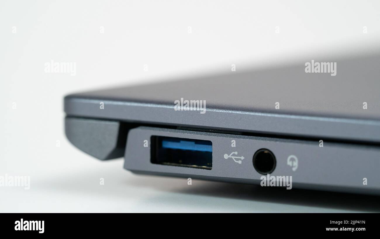 A closeup of a USB port on a grey laptop Stock Photo