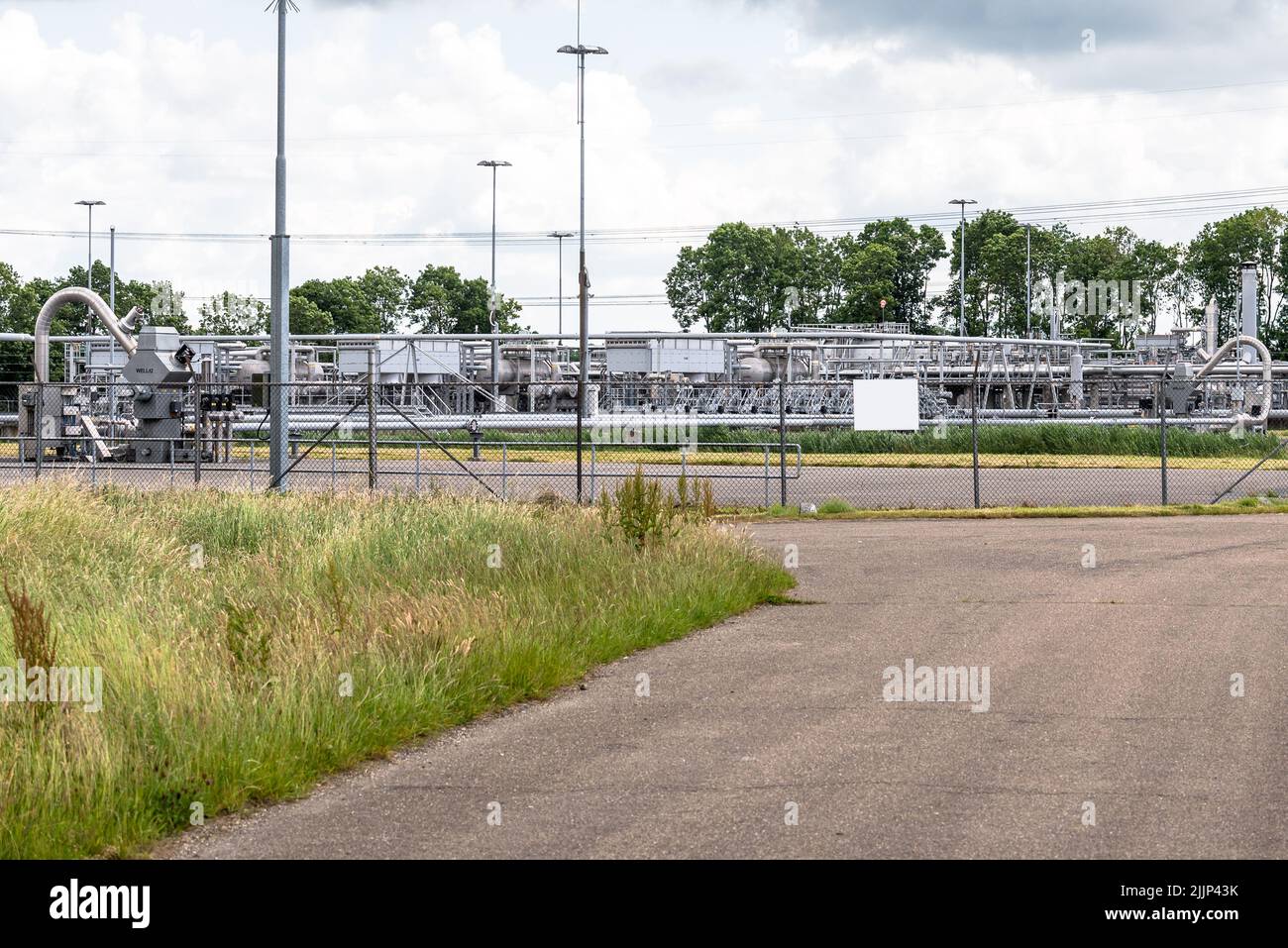 Wellheads and pipelines at a natural gas extraction site in the countryside. Groningen gas field. Stock Photo