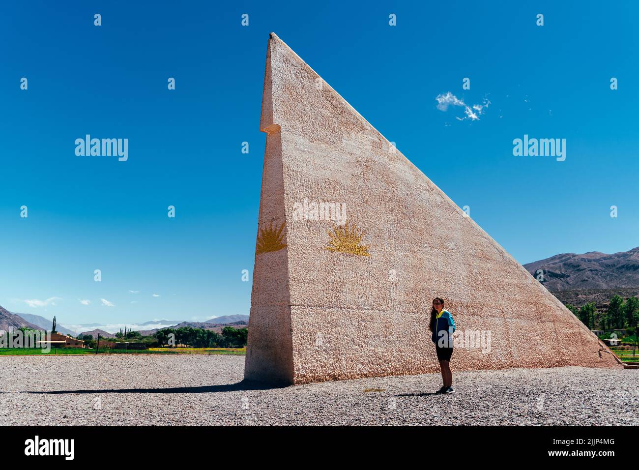 A woman standing in front of the Fiumara d'Arte - Pyramid Parallel 38 Stock Photo
