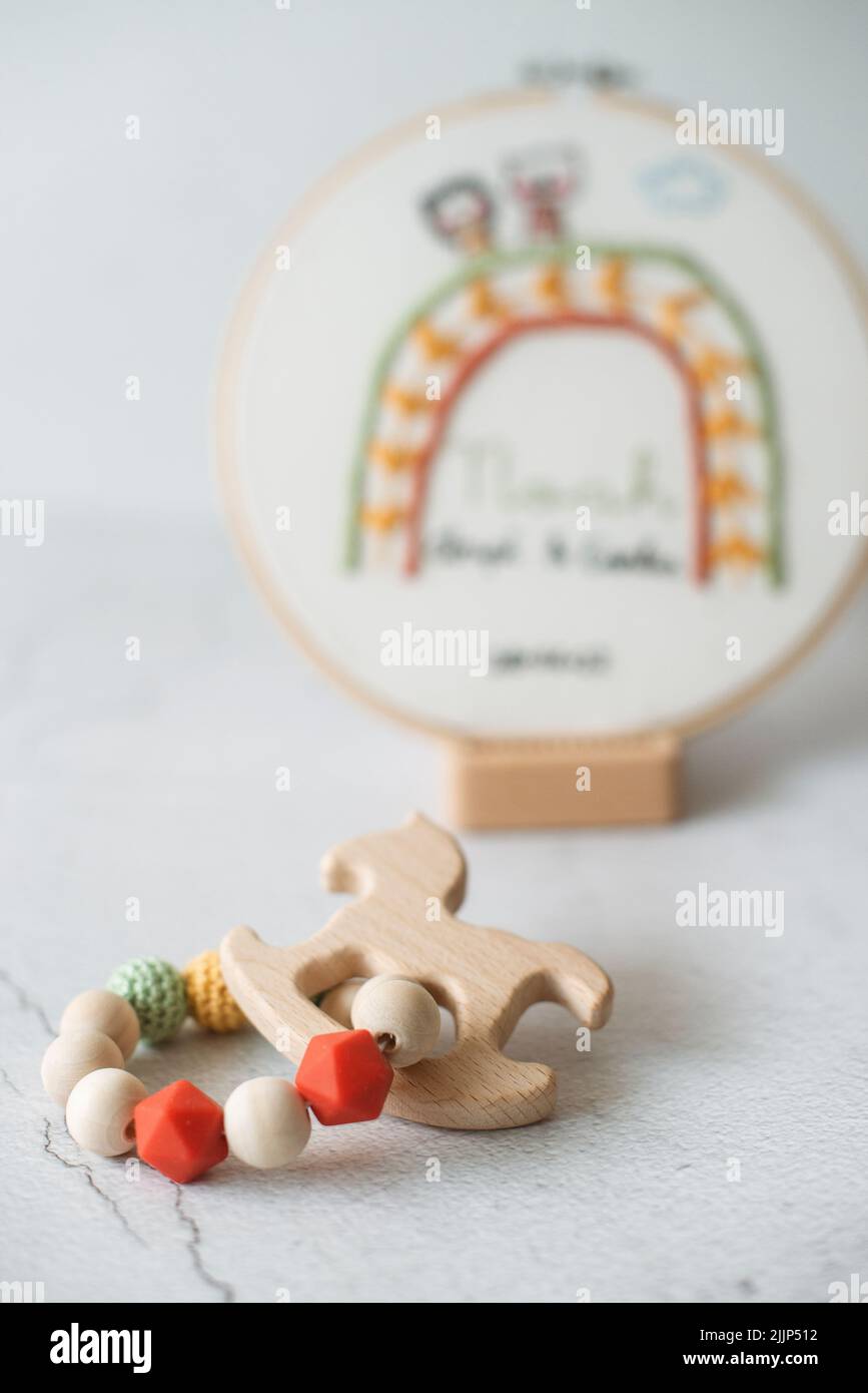 Close-Up of an embroidery hoop and teething toy on a table Stock Photo