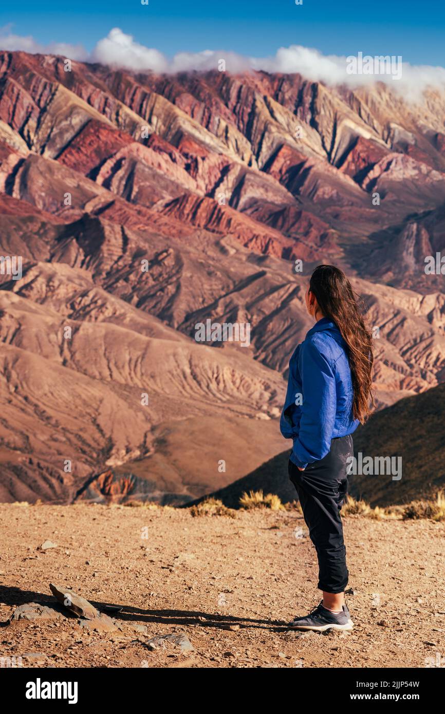 A woman standing and looking at Serrania de Ornocal mountains Stock Photo