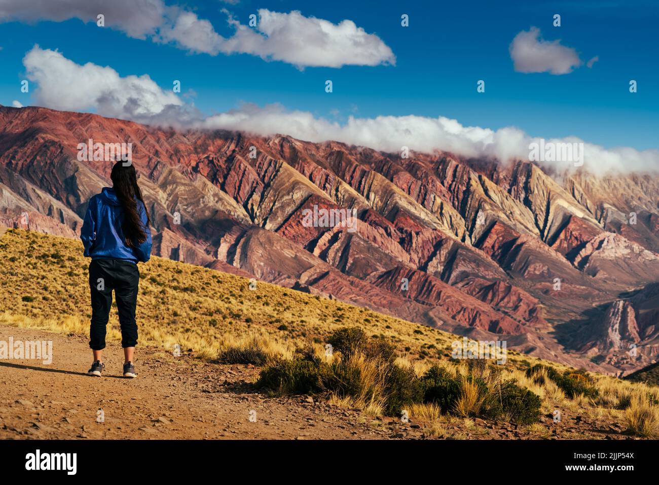 A woman standing and looking at Serrania de Ornocal mountains Stock Photo