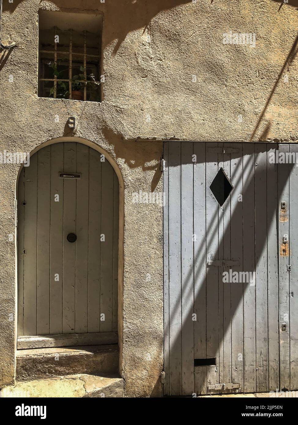 Aix-en-Provence, France, May 2022, view of a house with wooden shutter door Stock Photo