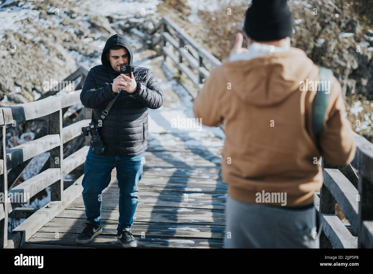 A Two young males taking photos outdoors Stock Photo
