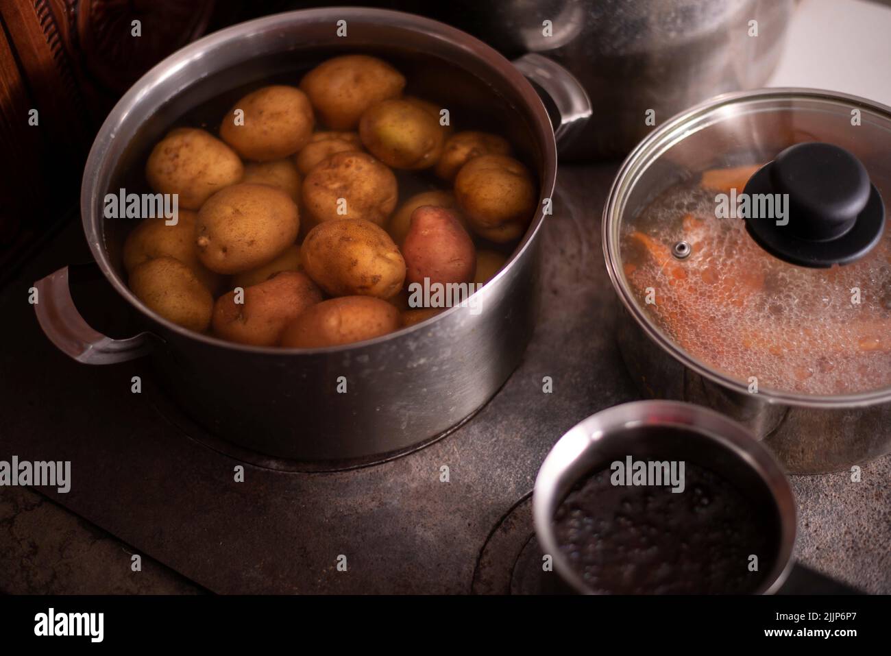 The carrots and potatoes boiling in pots Stock Photo Alamy