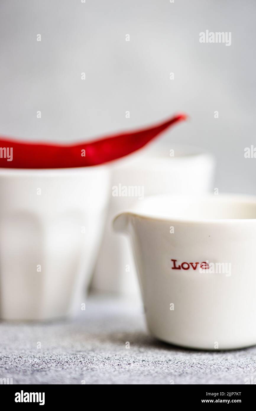 Close-up of a cup with the word love and a red chilli pepper Stock Photo