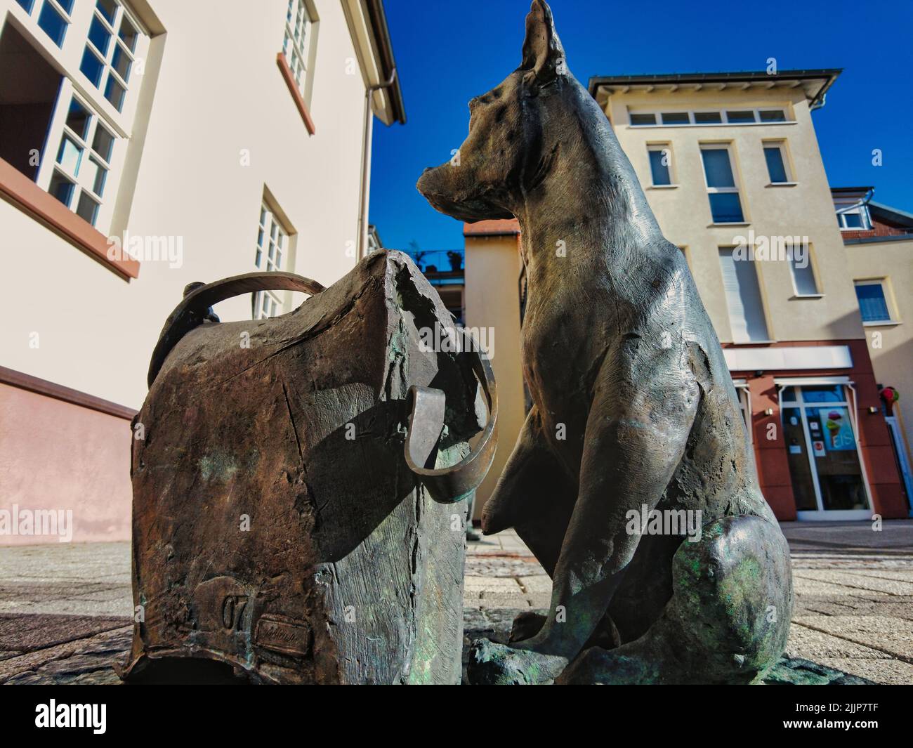 An old sculpture of a dog in Dreieich, Germany on a street Stock Photo
