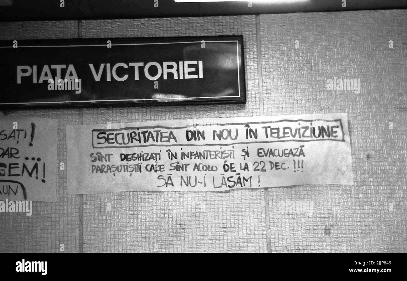 Bucharest, Romania, January 1990. In the confusing times after the anticommunist revolution of 1989, some people would try to communicate by posting messages in downtown Bucharest. A poster in the subway warns: 'The Secret Police again in the Public Television. They are disguised as soldiers and they evacuate the paratroopers that are there since December 22nd!!! Let us not allow them!' Stock Photo