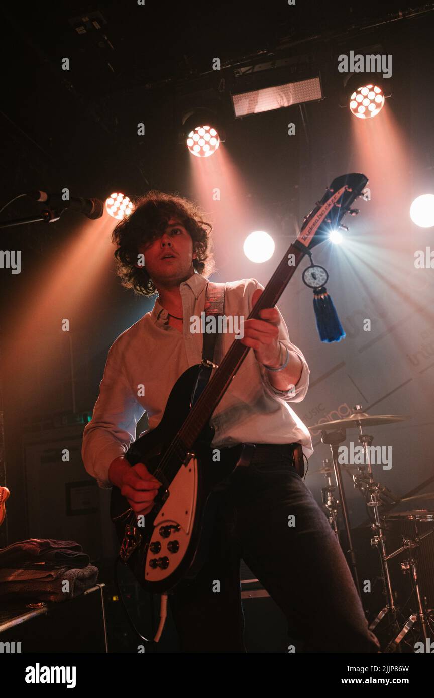 The Lathums band performing live at a concert, focus on lead guitarist