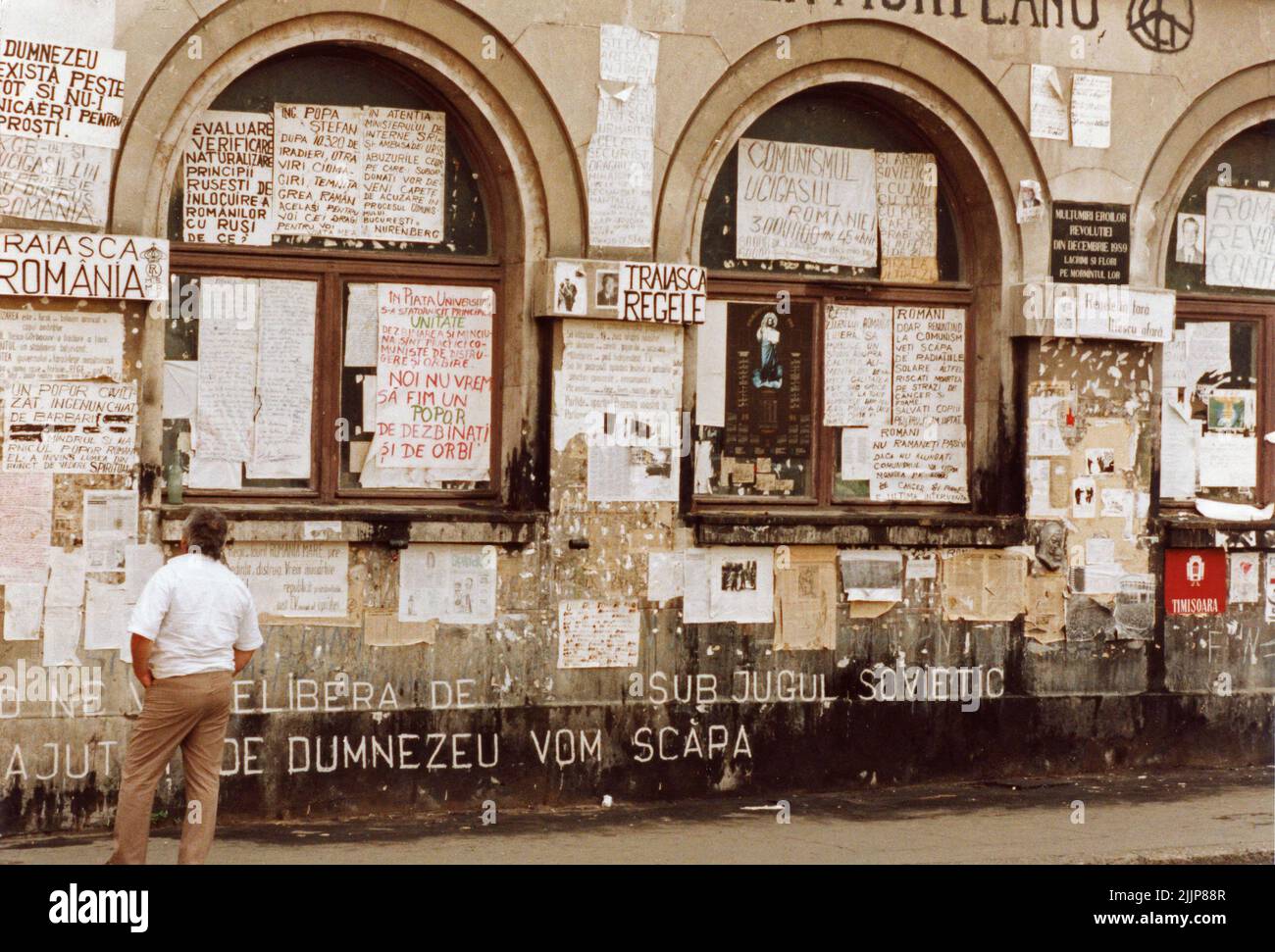 Bucharest, Romania, 1990. A few months after the anticommunist revolution of 1989, the facade of the University of Architecture is still covered in posters and messages posted by people during the uprising. The University Square, one of the key points in the revolution, remained a battle ground against the new political system, composed mainly of former communist officials. Stock Photo