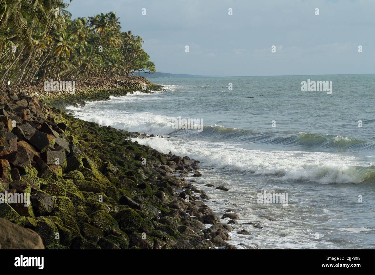 A rocky shore at the Thirumullavaram Beach, Kerala, India Stock Photo