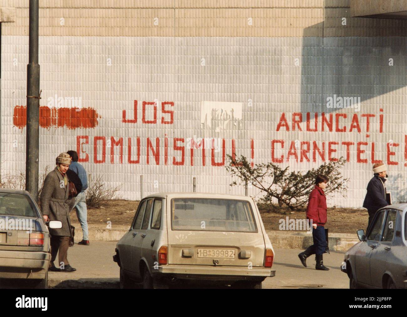Bucharest, Romania, January 1990. Messages written by the revolutionaries in downtown Bucharest during the anticommunist uprising of December 1989: 'Down with communism' & 'Throw away your (Communist Party) IDs'. Stock Photo
