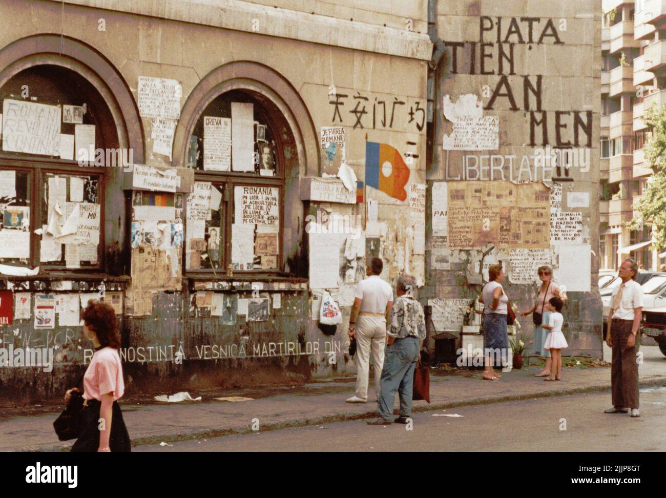 Bucharest, Romania, 1990. A few months after the anticommunist revolution of 1989, the facade of the University of Architecture is still covered in posters and messages posted by people during the uprising. The University Square, one of the key points in the revolution, remained a battle ground against the new political system, composed mainly of former communist officials. Stock Photo