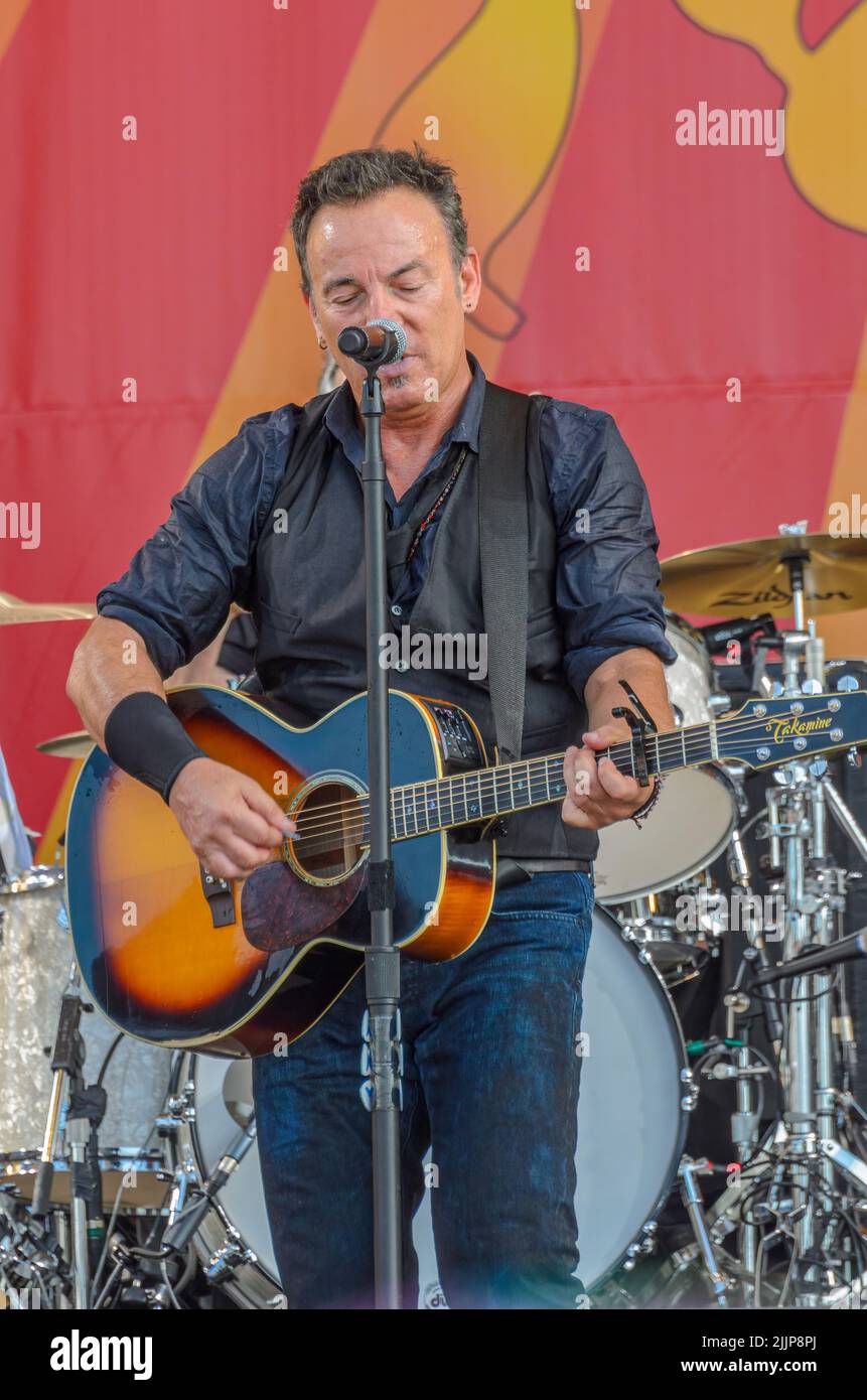 Bruce Springsteen plays acoustic guitar at the New Orleans Jazz and Heritage Festival on April 29, 2012 Stock Photo