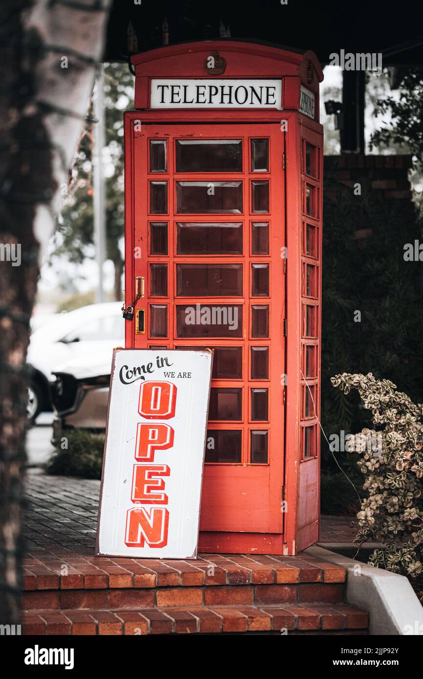 A red phone booth with open sign in Tustin, USA Stock Photo