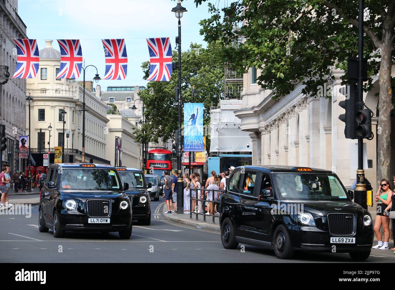 LONDON BLACK TAXIS PASSING FROM STRAND TO TRAFALGER SQUARE IN LONDON Stock Photo