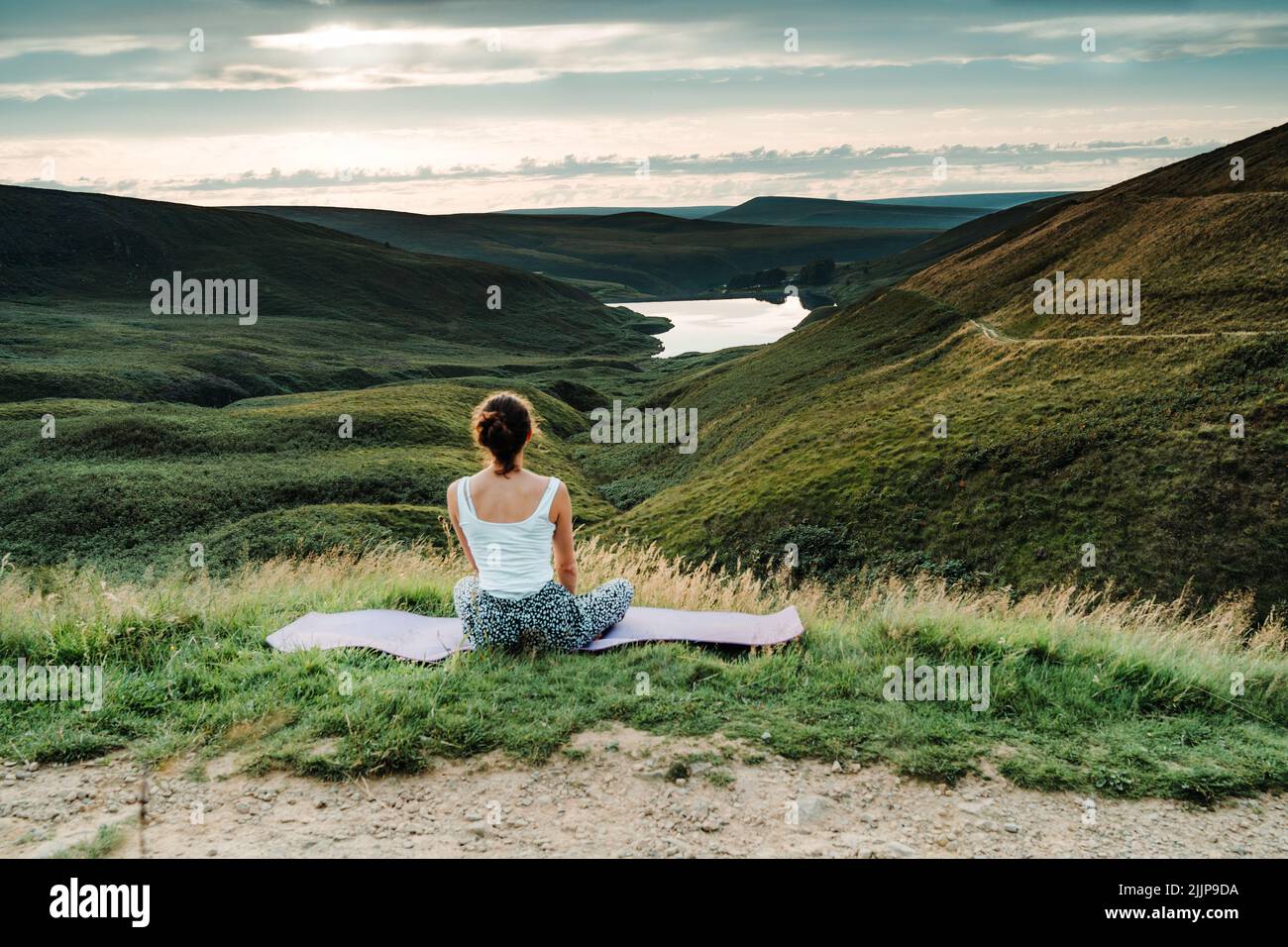Wessenden Head Reservoir seen from the drone, woman watching sunset at Peak District National Park during summer time, England, UK Stock Photo