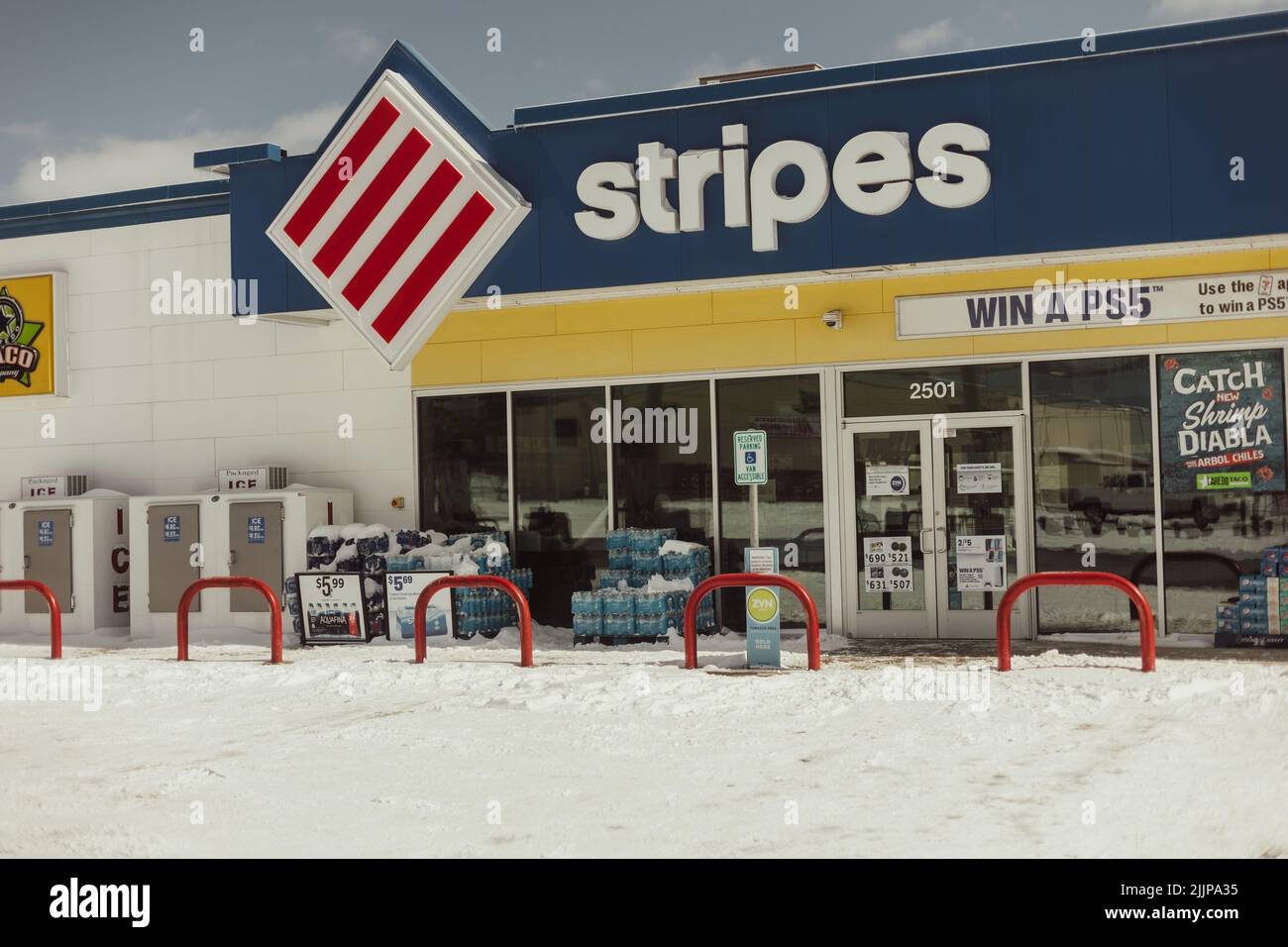 A view of a snowed gas station convenience store Stock Photo