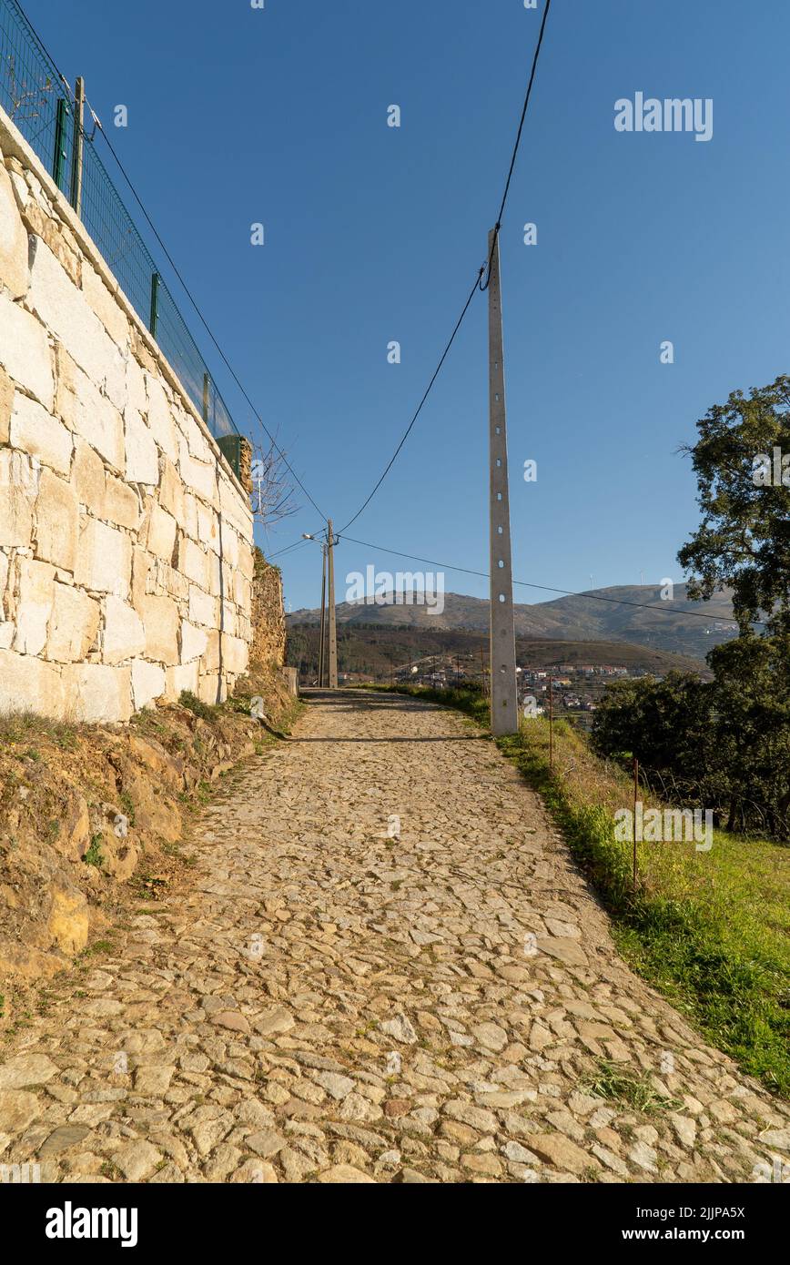 The clear blue sky over the stone footpath on a sunny day in summer Stock Photo